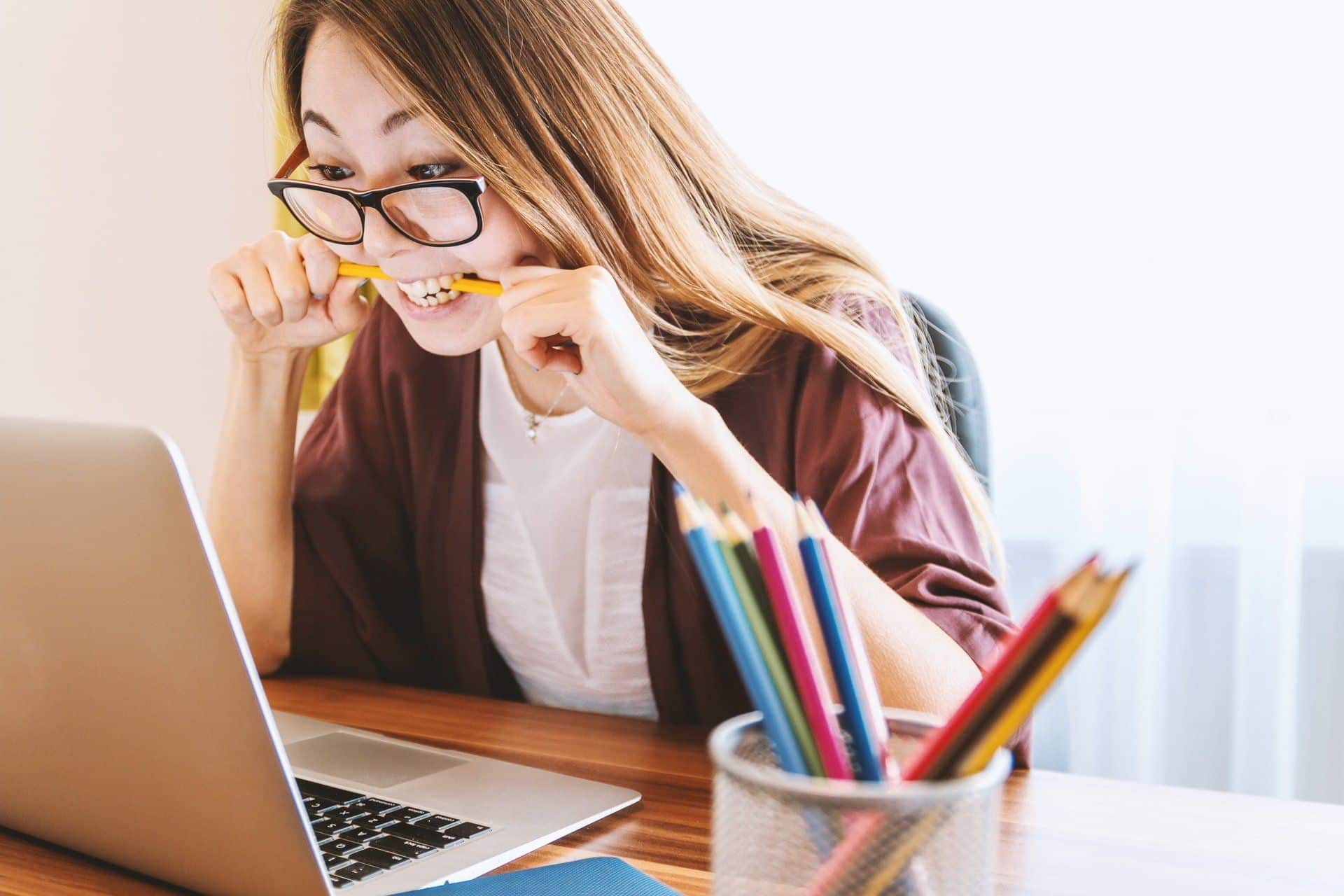 woman biting pen