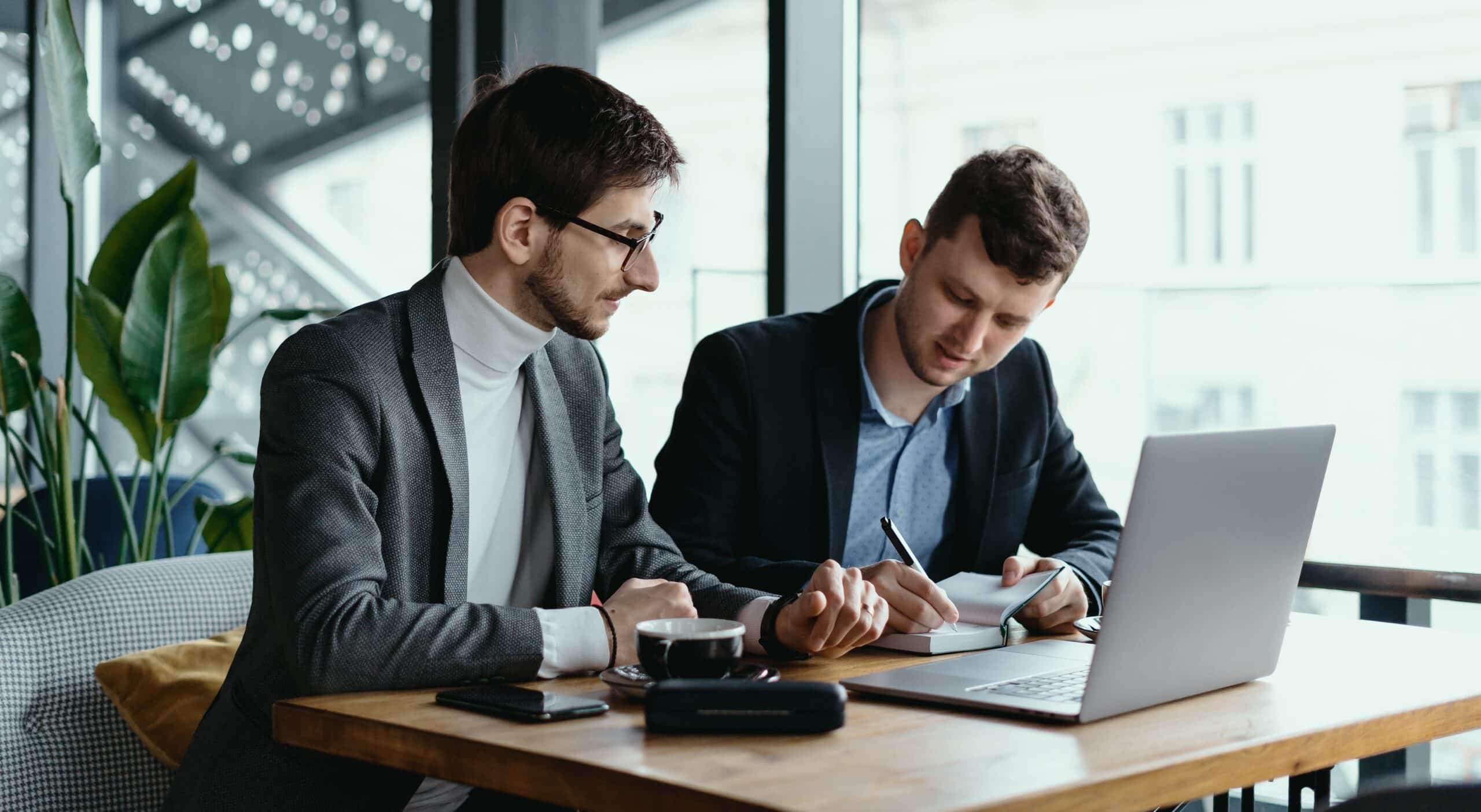 businessmen at table with laptop